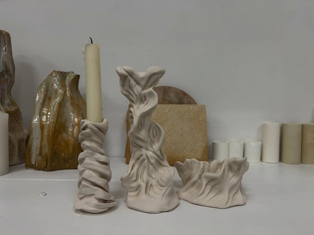 Three hand-built ceramic candleholders by Naomi Tromp, in cream stoneware.